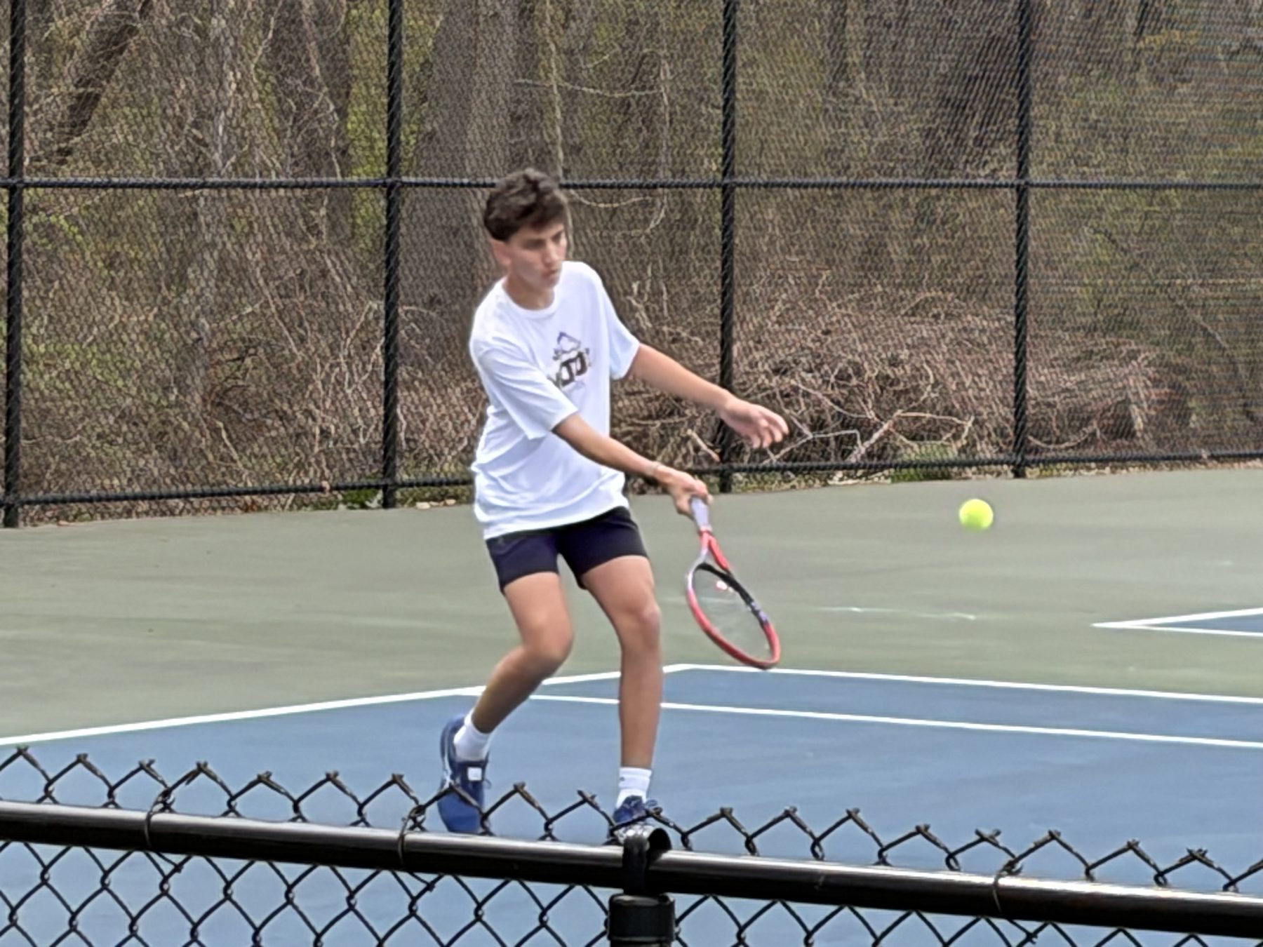 Me mid-swing on the tennis court